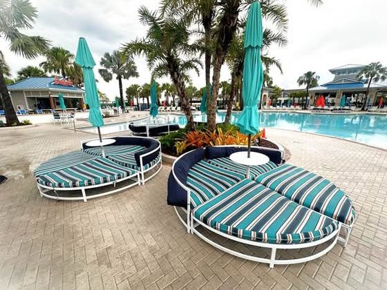 Striped cushioned poolside daybeds beside the pool at Windsor Island Resort