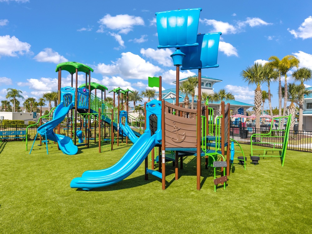 Nautical pirate-ship themed children's playground on turf at Windsor Island Resort